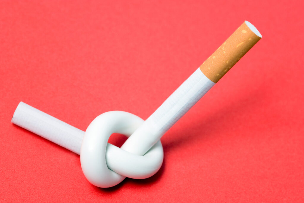 Quit smoking represented by a cigarette tied in a knot